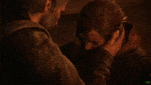a man holds a woman 's face and says " ellie he tried to "