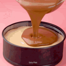 caramel is being poured into a cake pan which says easy plus on the bottom