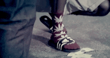 a person wearing a pair of socks with marijuana leaves