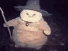a stuffed animal wearing a hat and holding a cane .