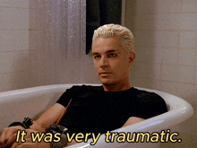 a man laying in a bathtub with the words " it was very traumatic " below him
