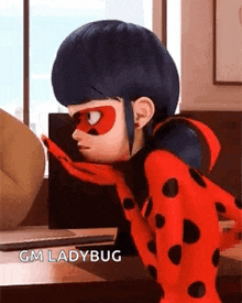 ladybug from miraculous ladybug is sitting at a table with a scarf around her neck and a mask on her face .