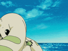 a cartoon character laying on the beach with the ocean behind it