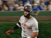 a baseball player wearing a san francisco jersey is walking on the field