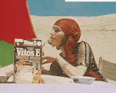 a woman sitting at a table with a box of vitos e toasted muesli in front of her