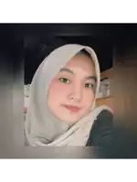 a woman wearing a white hijab and a black shirt looks at the camera