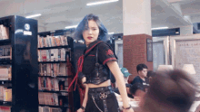 a woman with blue hair stands in front of a shelf with a number 3 on it