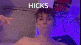 a man is looking at a laptop with the word hicks on the screen
