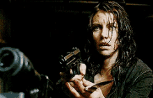a woman with blood on her face is looking at a man .