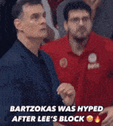 a man in a suit and a man in a red shirt with the word bwin on it
