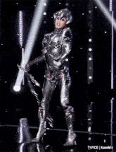 a woman in a futuristic costume is on stage