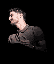 a man with a beard and a watch on his wrist is smiling