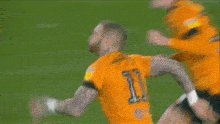 a soccer player with maddison on the back of his jersey kneeling on the field