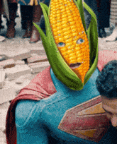 a man in a superman costume has a corn on the cob instead of a face
