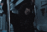 a blurry picture of a person in a dark room reaching for something
