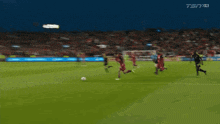 a man taking a picture of a soccer game with a banner that says one club