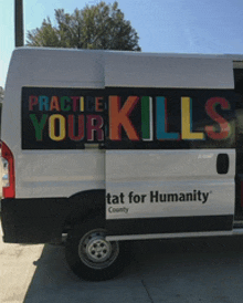a white van that says practice your kills on it