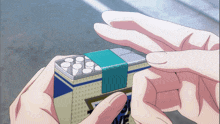 a person is holding a box of cigarettes with a blue band around the edges