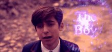 a boy in a suit and tie is surrounded by purple lights and the words the boy