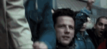 a group of people are holding their arms in the air .