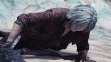 a man with gray hair is laying on the ground with the year 2012 visible