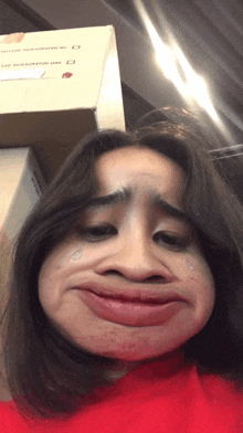a woman is making a funny face in front of a box that says ' a.m. bakery '