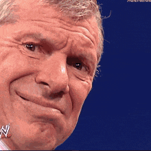 a close up of a man 's face with a w on his earring