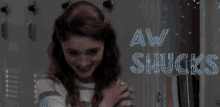 a woman in a striped shirt stands in front of a sign that says aw shucks