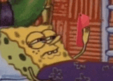 spongebob squarepants is laying in a bed holding a pink heart .