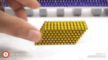a bunch of gold beads are stacked on top of each other with the words diy wonderful in the corner