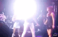 a blurry picture of a group of people dancing on a stage with the words rbd.gif on the bottom