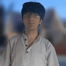 a man wearing glasses and a white shirt