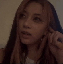 a woman with long hair making a funny face