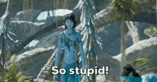 a woman in a blue avatar costume stands in a jungle with the words so stupid below her