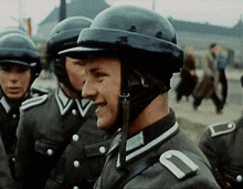 a man wearing a black helmet with the letter u on his shoulder