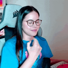 a woman wearing glasses and a blue shirt with a corsair logo on it