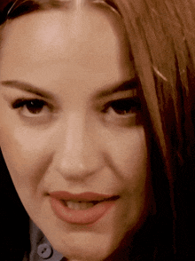 a close up of a woman 's face with red lipstick on