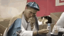 a man dressed as a doctor is holding a stethoscope in his hand .