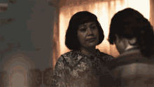 two women looking at each other in a dark room with netflix written on the bottom