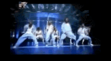 a group of people are dancing in front of a sign that says ' nbc '