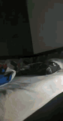 a person is laying on a bed with a blue shirt on