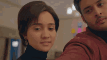a man and a woman looking at each other in a room