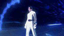 a man in a white suit is standing in front of a blue background