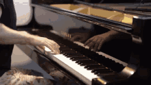 a person is playing a yamaha piano with their hands on the keys