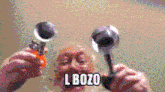 a pixelated image of an elderly man holding a pair of wrenches with l bozo written on the bottom right