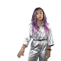 a woman with purple hair is wearing a silver jumpsuit and pointing