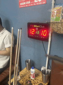 a billiard club scoreboard displays a score of 12 to 13
