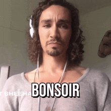 a man wearing headphones has the word bonsoir written on his chest