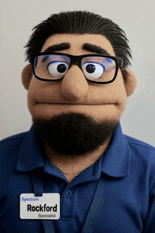 a puppet with glasses and a name tag that says spectrum rockford specialist