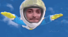 a man is flying through the air wearing a helmet and gloves .